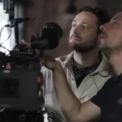 Dwóch mężczyzn przy profesjonalnej kamerze filmowej, jeden z nich reżyser Daniel Jaroszek.