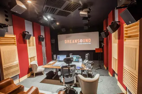 Profesjonalne studio nagraniowe DreamSound z konsolą mikserską, monitorami studyjnymi i ekranem projekcyjnym.