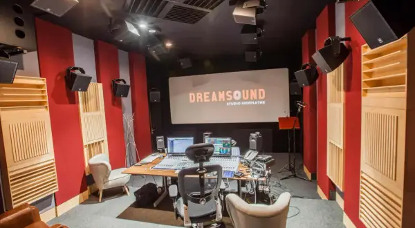Profesjonalne studio nagraniowe DreamSound z konsolą mikserską, monitorami studyjnymi i ekranem projekcyjnym.